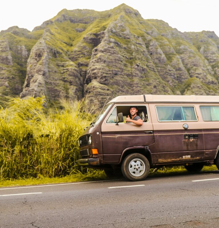 green van on gray asphalt road during daytime