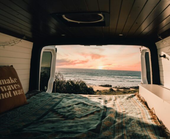 a bedroom with a bed and a view of the ocean